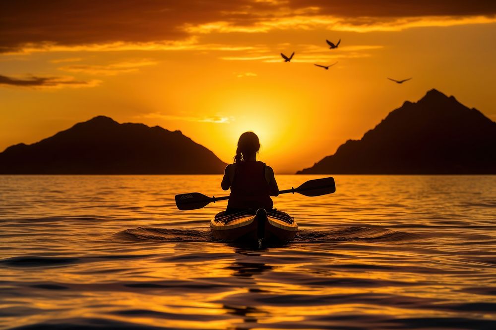 Silhouette of woman on ocean kayak silhouette recreation kayaking.