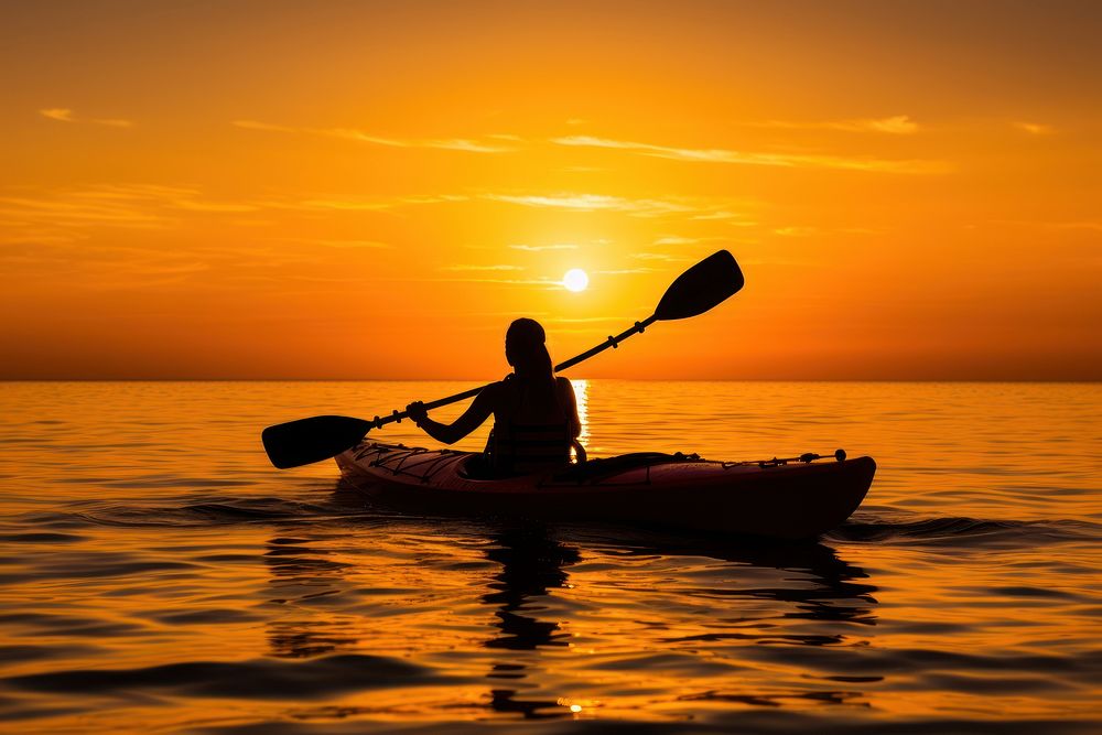Silhouette of woman on ocean kayak silhouette recreation kayaking.