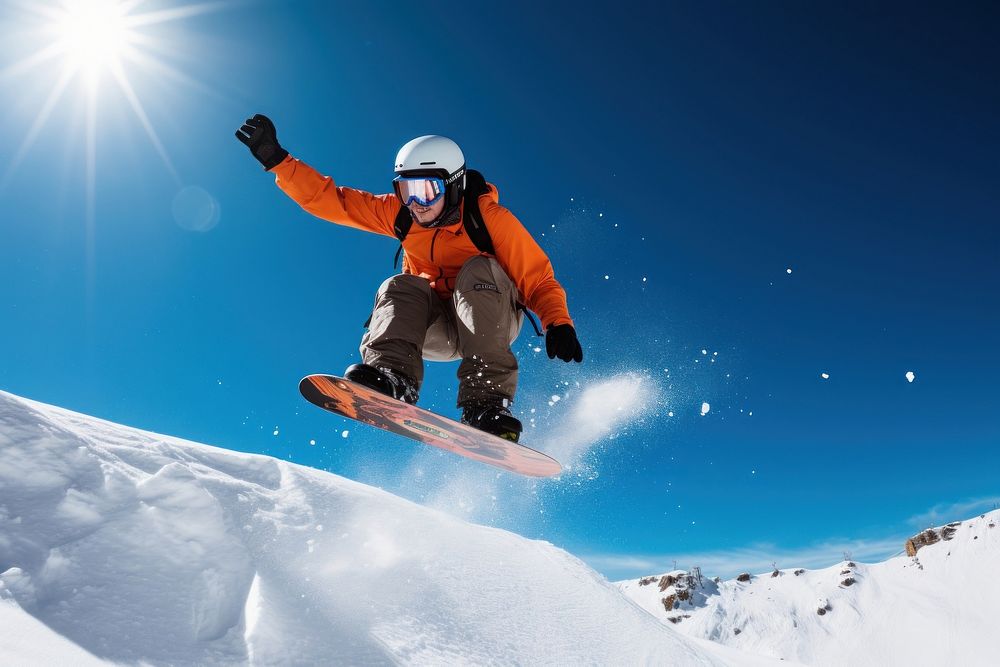 Snowboarder jumping against blue sky snow snowboarding recreation.