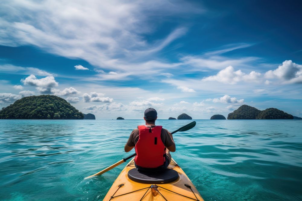 Traveler kayaking in the thai ocean from backward view vehicle sports canoe.