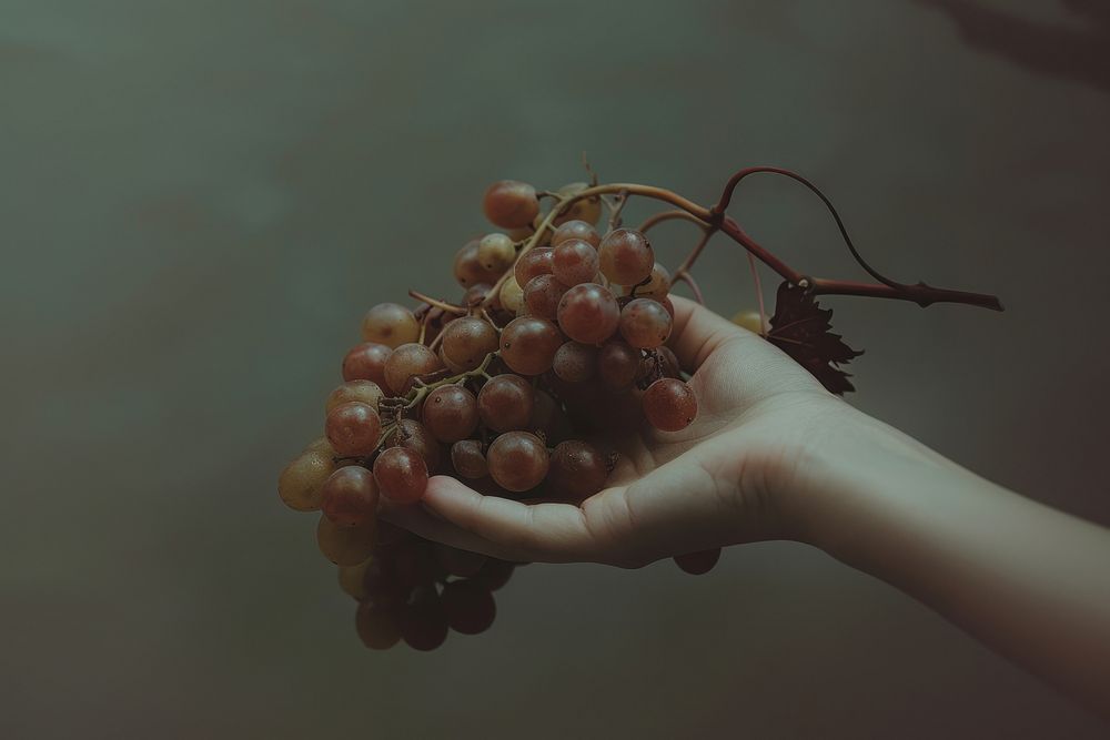Hand holding grapes fruit plant food.