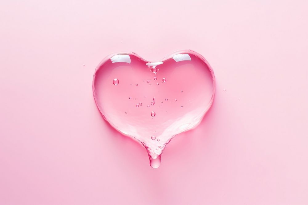 Water in heart shape pink red pink background.