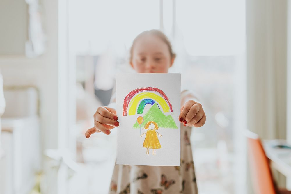 Little girl showing coloring artwork