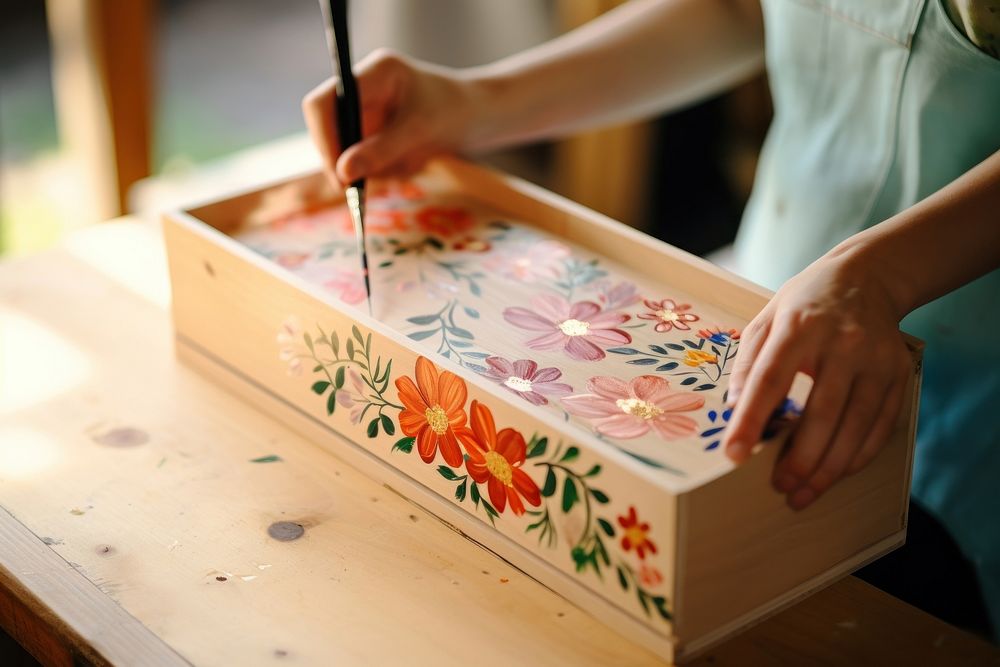 Hand painting on wooden box brush craftsperson paintbrush.