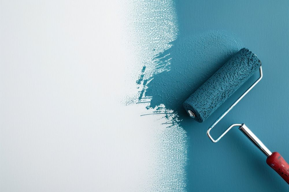 Paint roller and painting a white wall blue screwdriver cleaning.