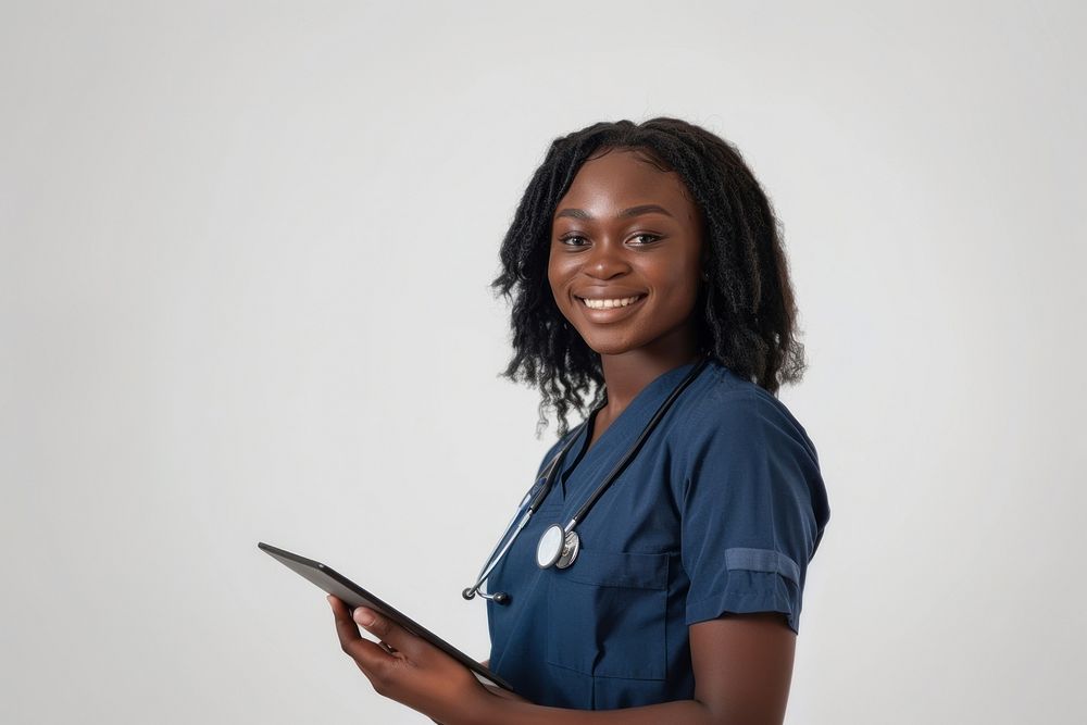 African american woman nurse holding a tablet smiling white background stethoscope.