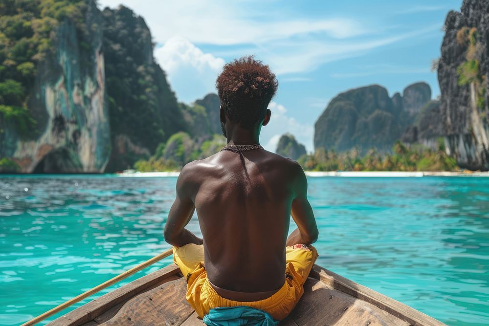 African man sitting in front of a boat back vacation day.