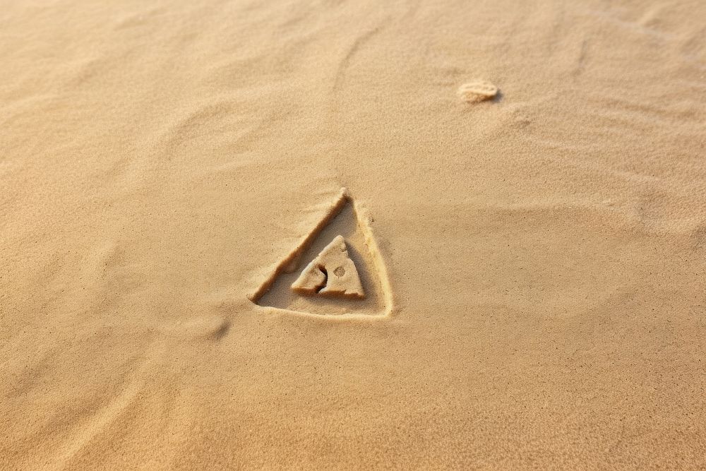 Triangle shape doodle finger-drawing outdoors sand footprint.