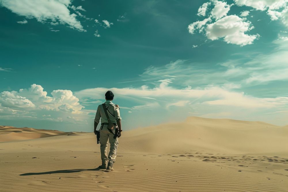 Thai man holding a gun in desert standing outdoors horizon.