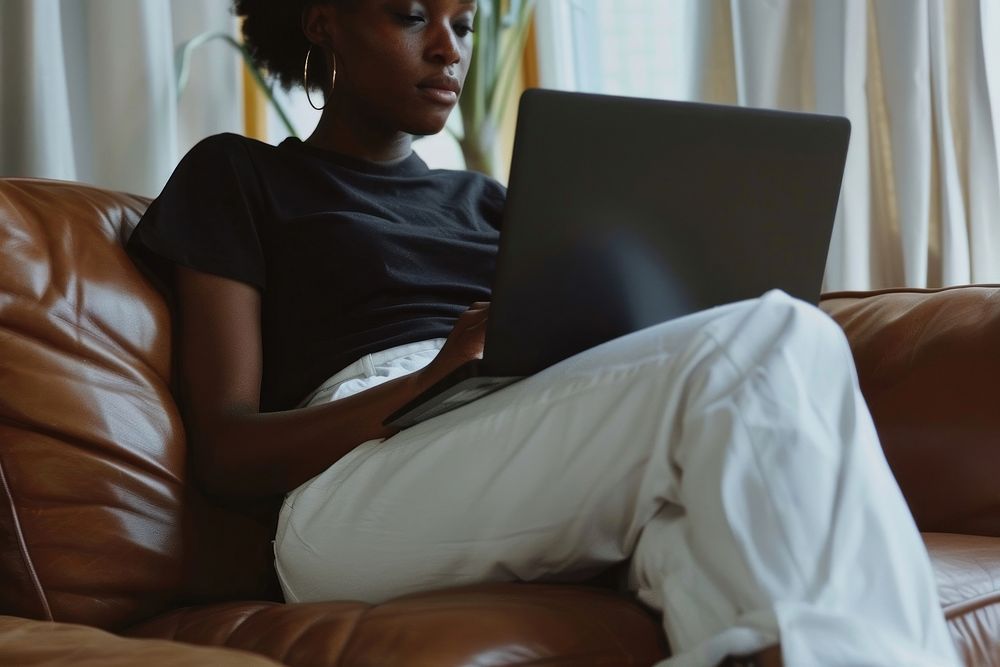 An American African woman sitting laptop electronics.