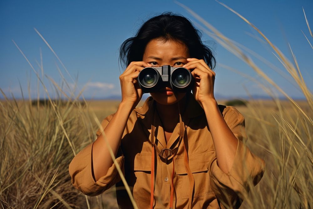 Woman using Binoculars binoculars photo photography.