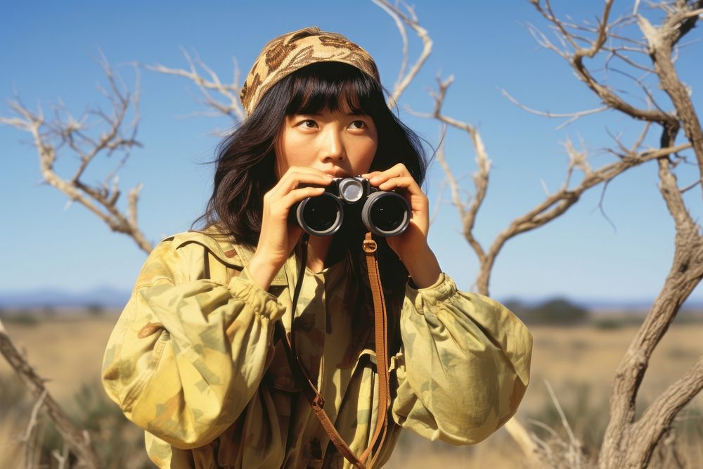 Woman using Binoculars photo photography electronics.