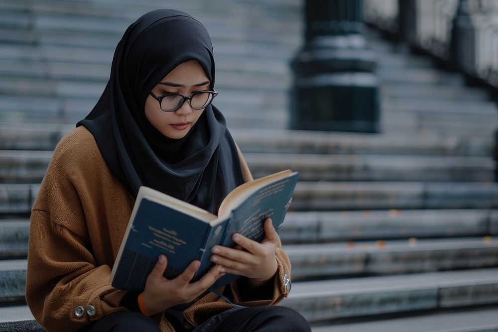 Teenager Indonesian woman reading book publication clothing.