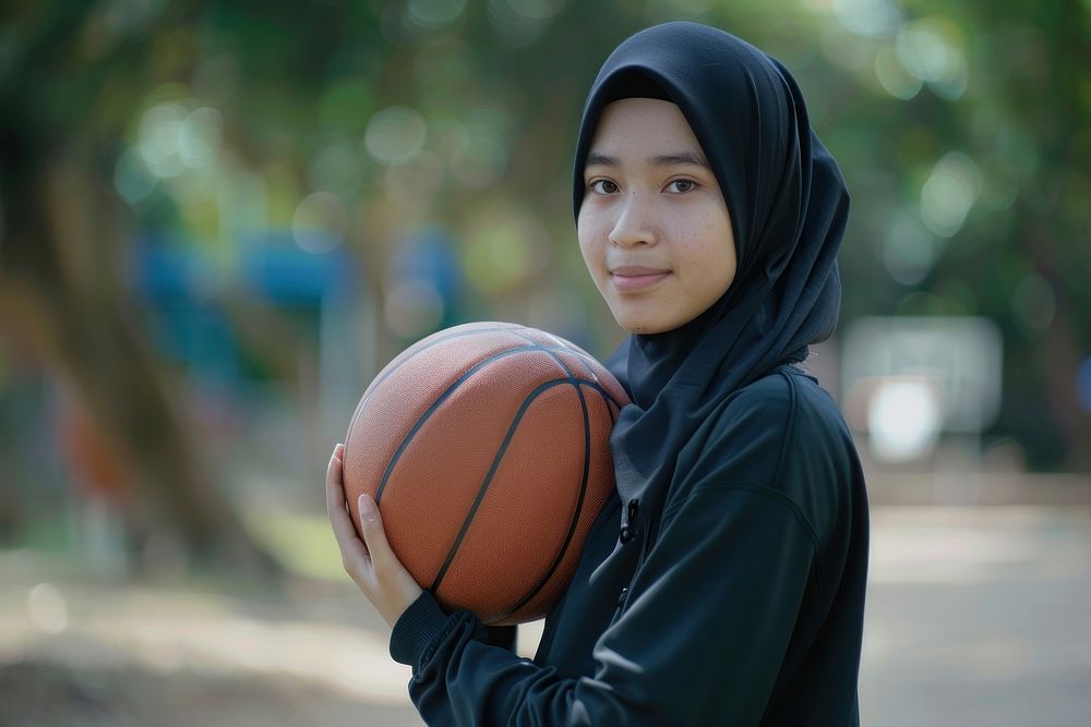 Indonesian woman holding basketball sports person female.
