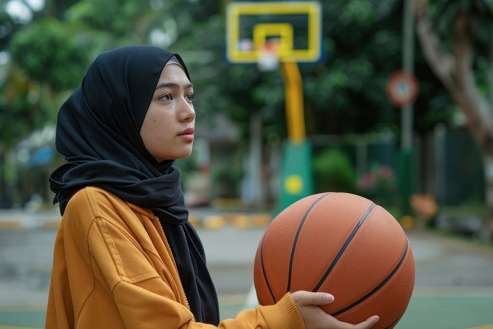 Indonesian woman holding basketball clothing apparel sports.