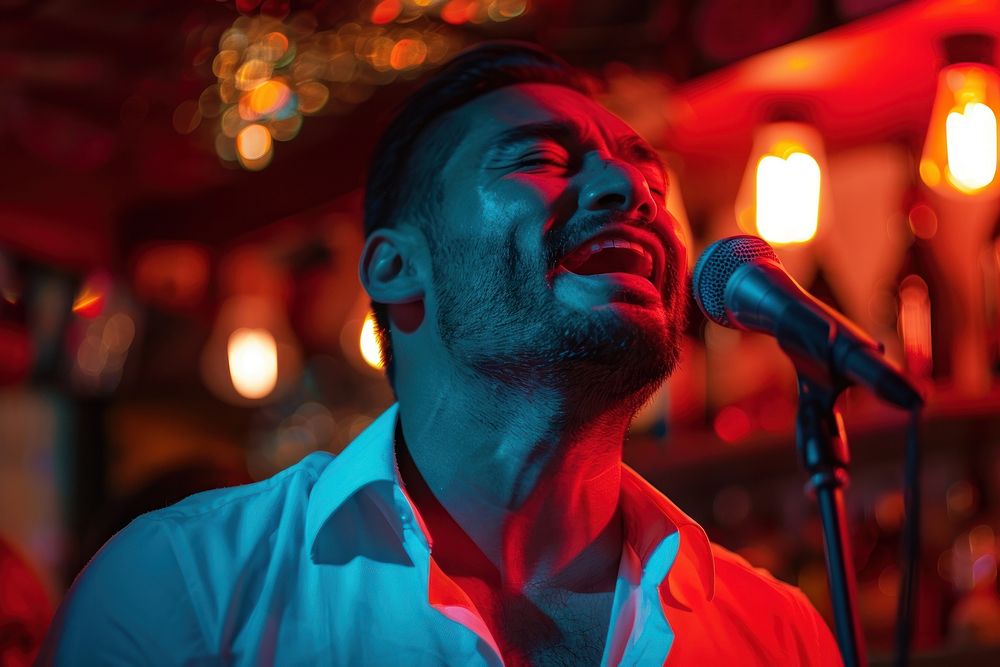 Hispanic man microphone performer lighting.