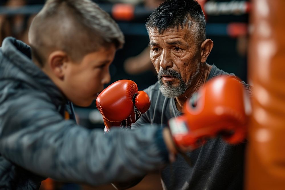 Hispanic dad and son boxing clothing punching.