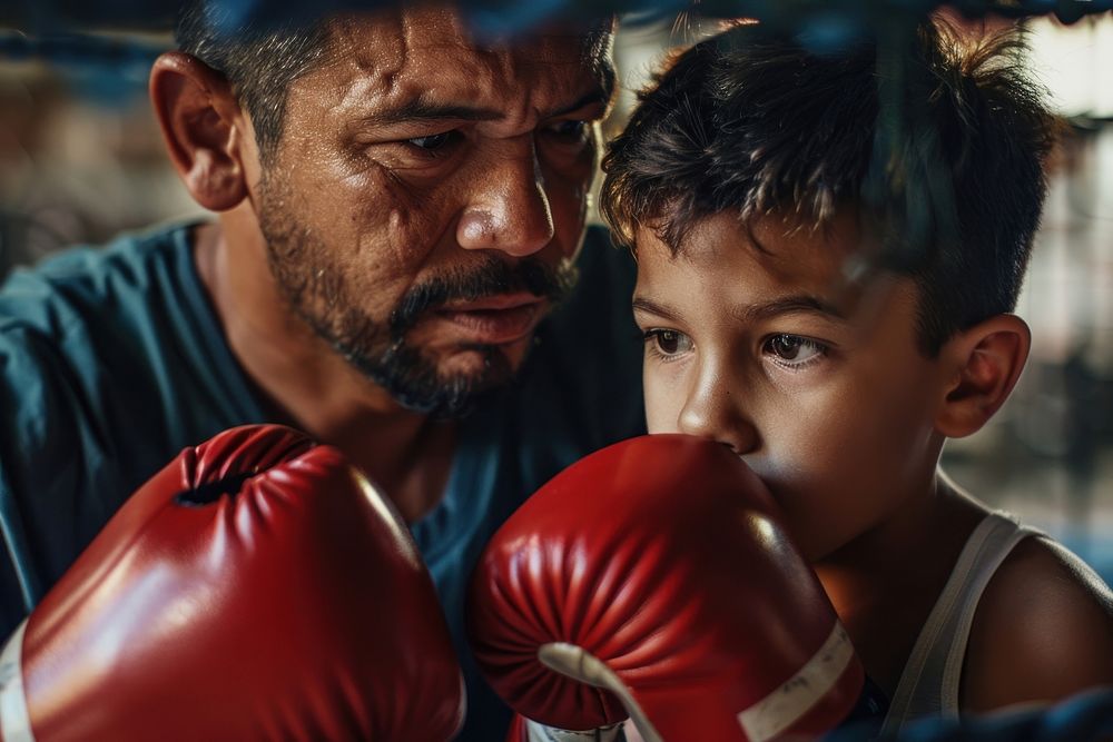 Hispanic dad and son boxing punching person.