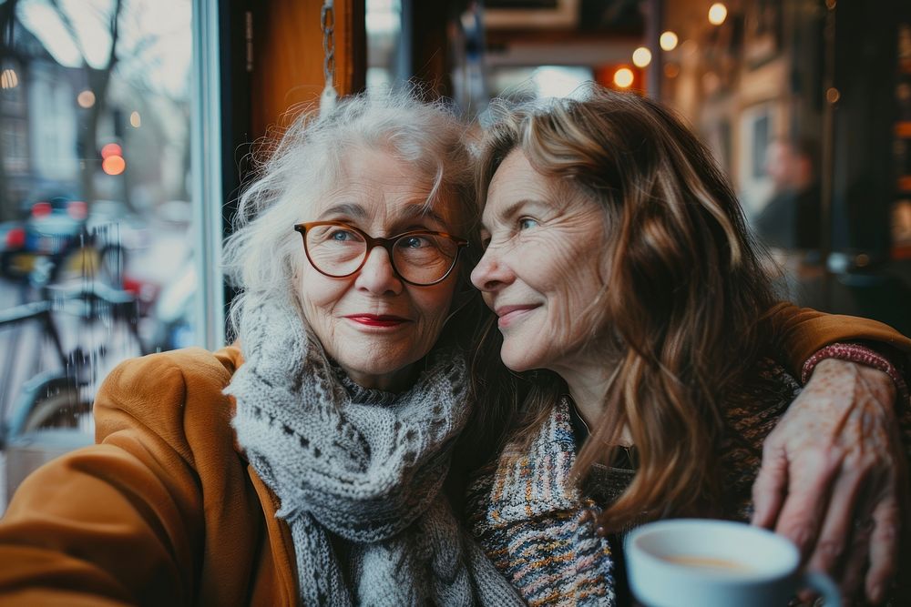 Senior mother and daughter laughing portrait glasses.