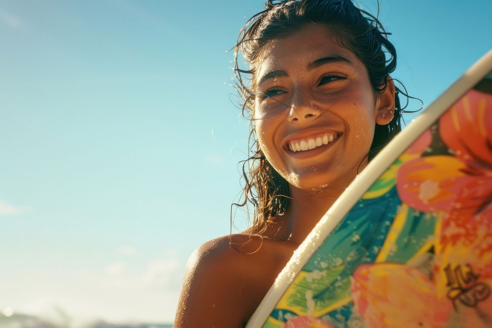 Hispanic woman carrying surfboard with her friend on the beach portrait photo photography.