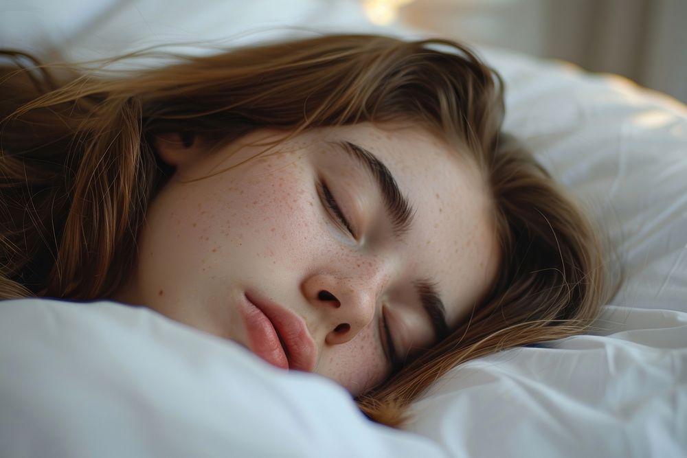 Woman sleep turn to camera side head on white pillow sleeping adult contemplation.