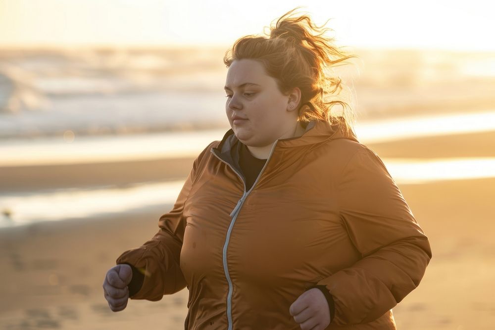 Chubby woman jogging by the beach portrait outdoors running.