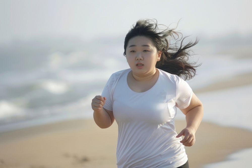 Chubby asian woman jogging by the beach outdoors running adult.