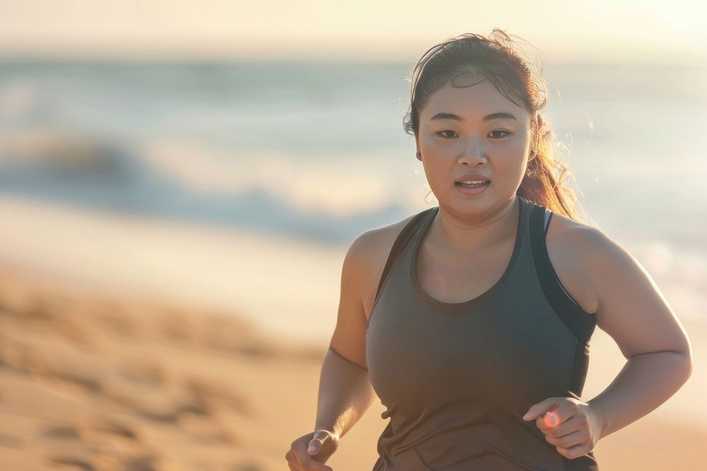 Chubby asian woman jogging by the beach running adult head.