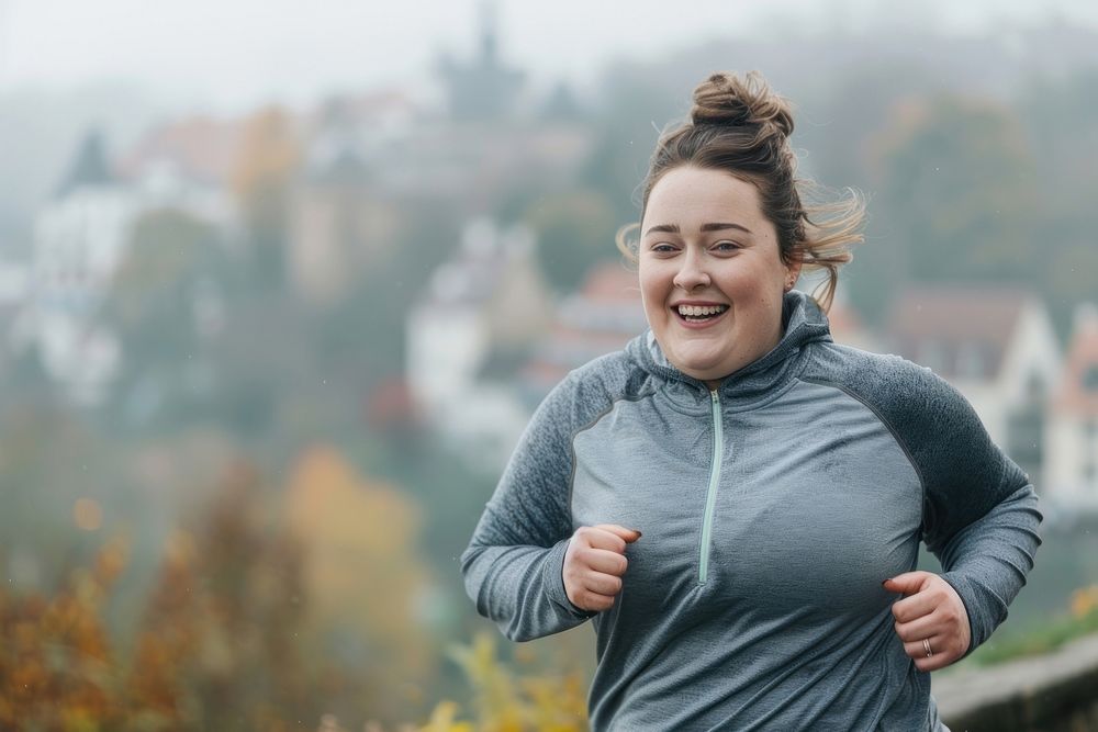 Happy chubby woman jogging in city portrait running smile.