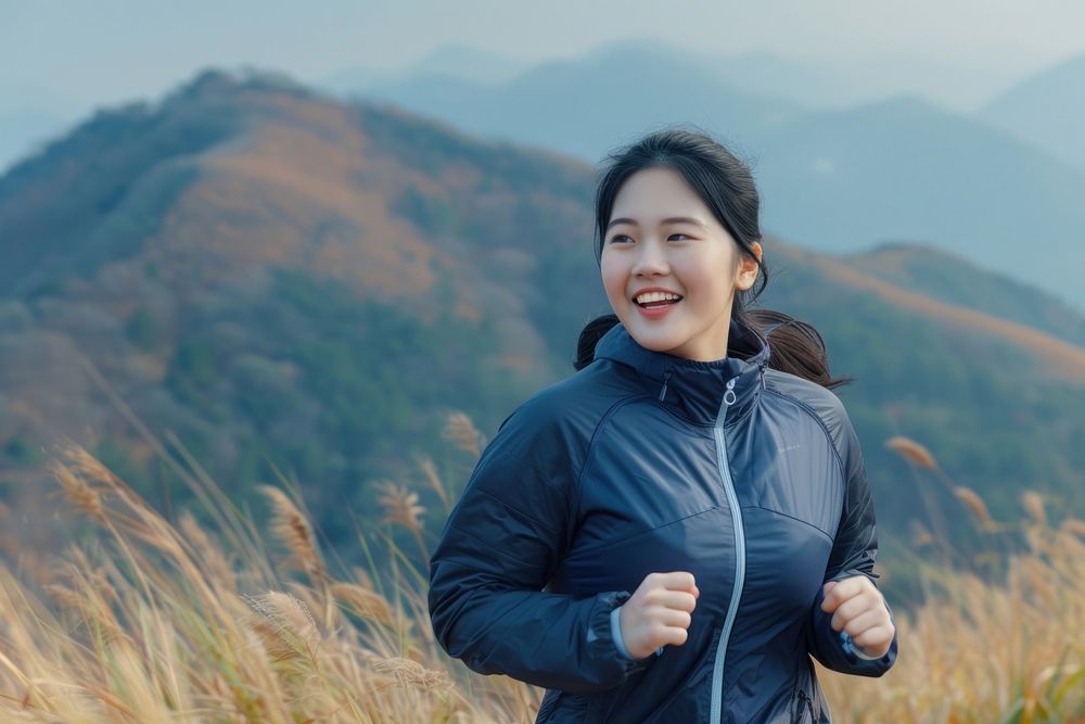 Happy chubby asian woman jogging at the mountain running smile adult.