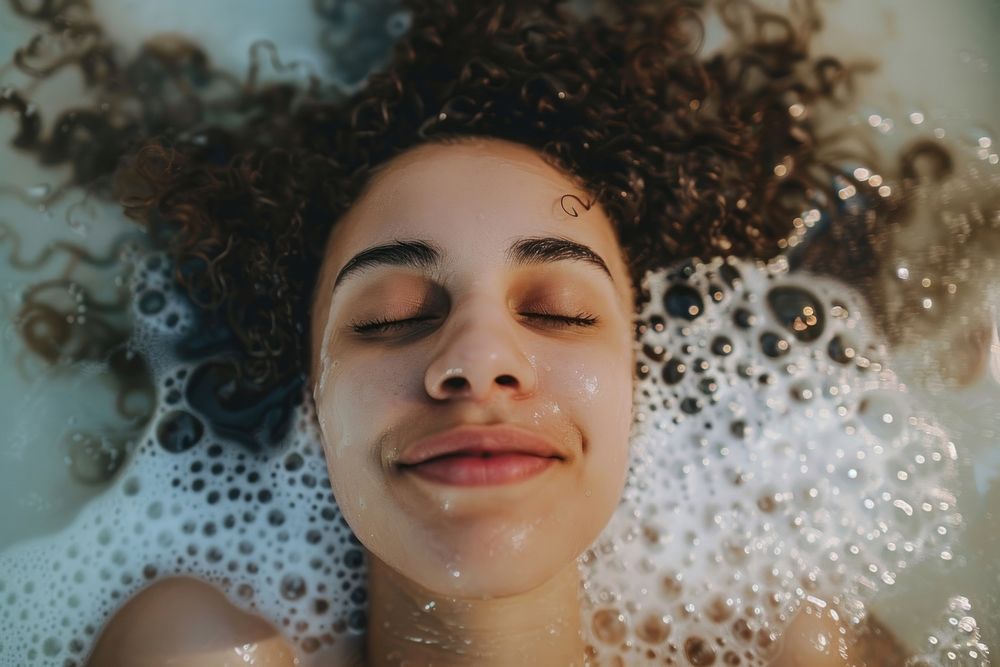 Relaxed woman in bubble bathtub adult relaxation happiness.