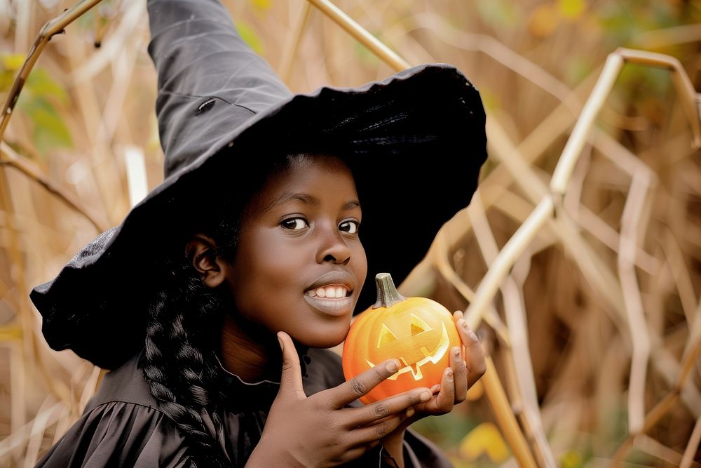 Girl dressed as a witch halloween adult jack-o-lantern.