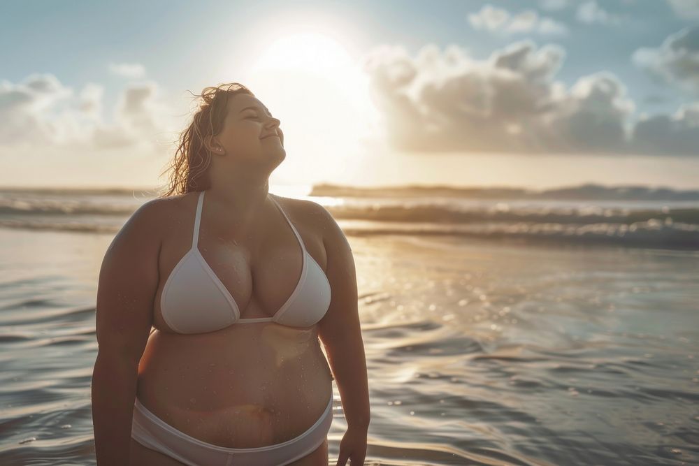 Happy chubby woman cool down after workout beach swimwear outdoors.