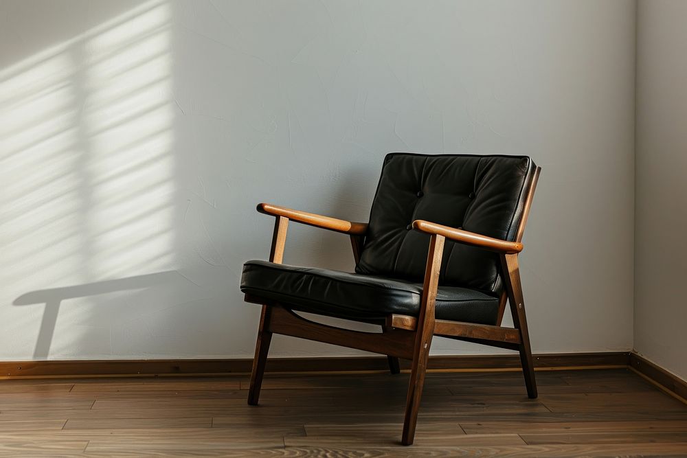 A midcentury wooden chair with black leather furniture armchair room.