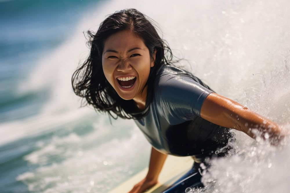 Singaporean woman surfing recreation laughing.
