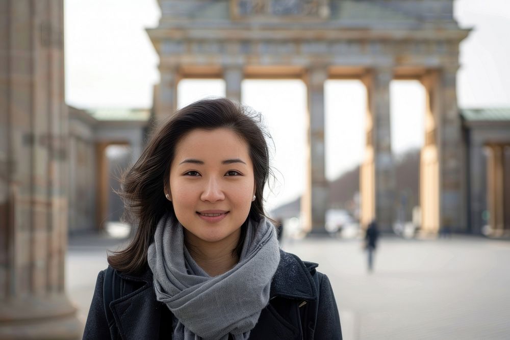 Asian woman travel to Germany at Brandenburg Gate landmark adult smile.