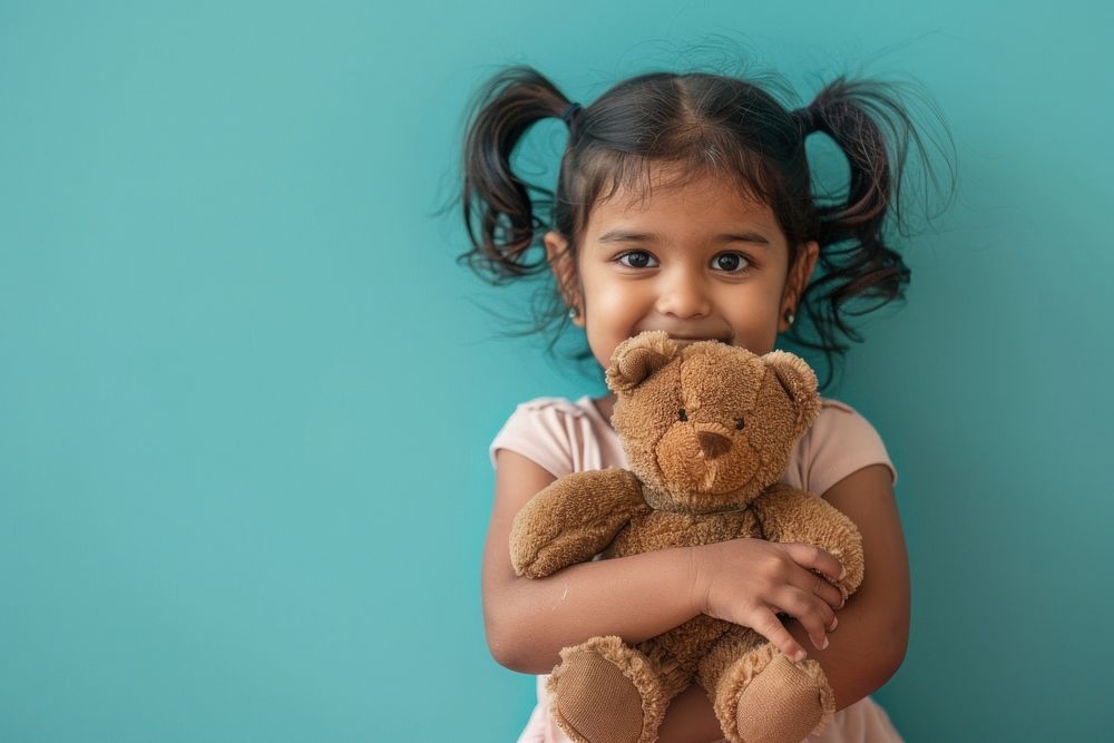 Indian kid happy girl teddy bear.