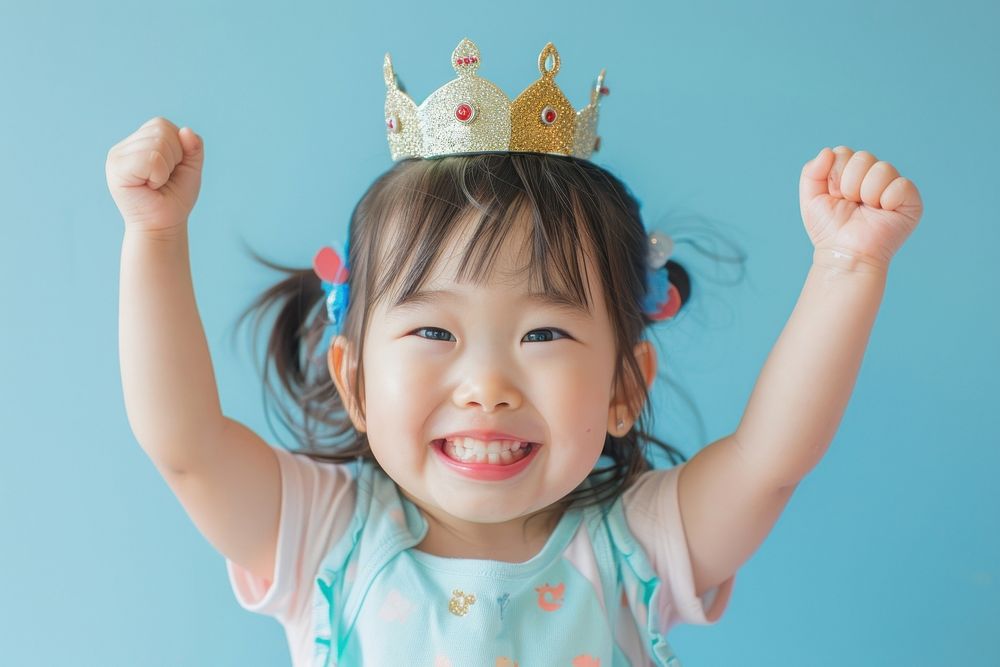 An asian girl toddler wear a crown portrait tiara smile.