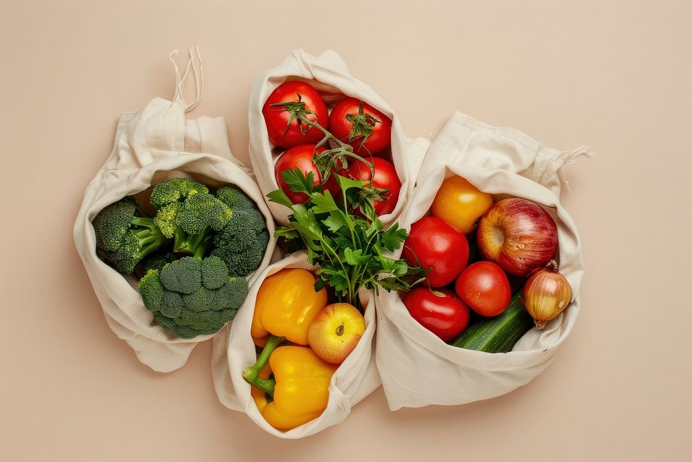 3 kind of fresh organic vegetable ingredients in reusable eco cotton bags fruit plant food.