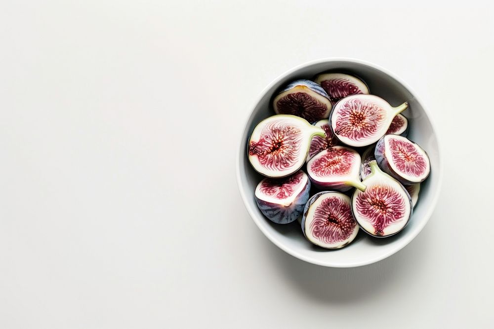 A bowl of fig produce fruit plant.