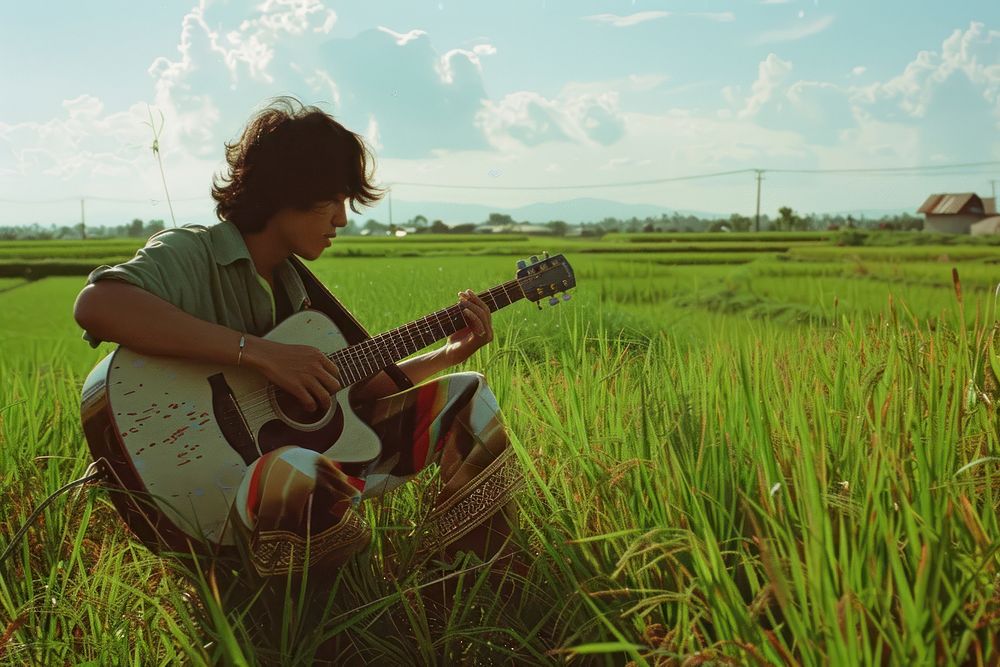 Thai man outdoors guitar playing guitar.