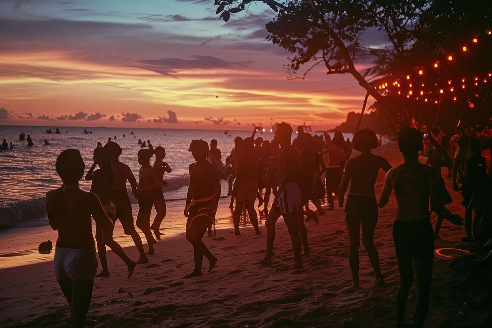 Thai people dancing at full moon party shoreline outdoors vacation.