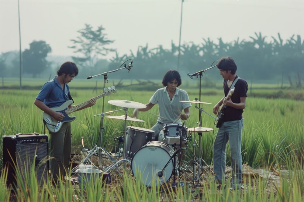 Thai rock band playing music outdoor concert at rice field outdoors electronics recreation.