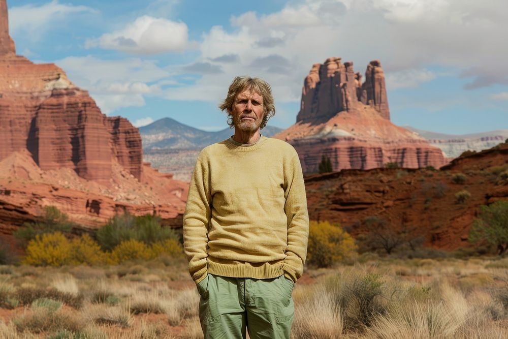Middle age man standing in front of red rock formations in Moab sweater clothing knitwear.