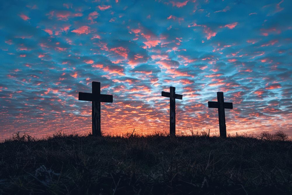 Three wooden crosses sky graveyard outdoors.