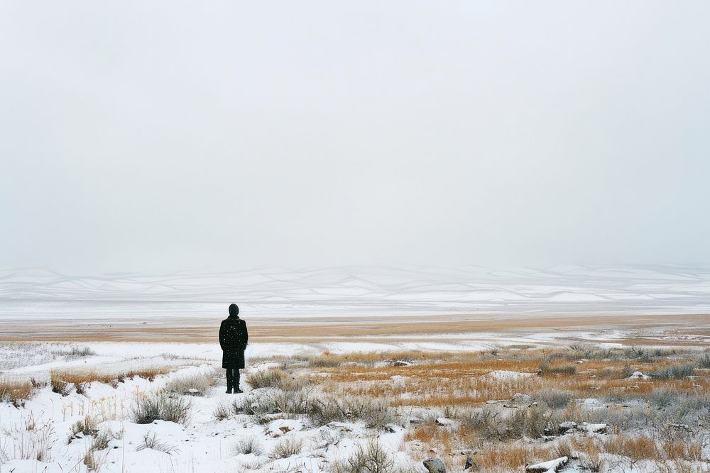 Lonely man stand in empty landscape winter outdoors walking scenery.