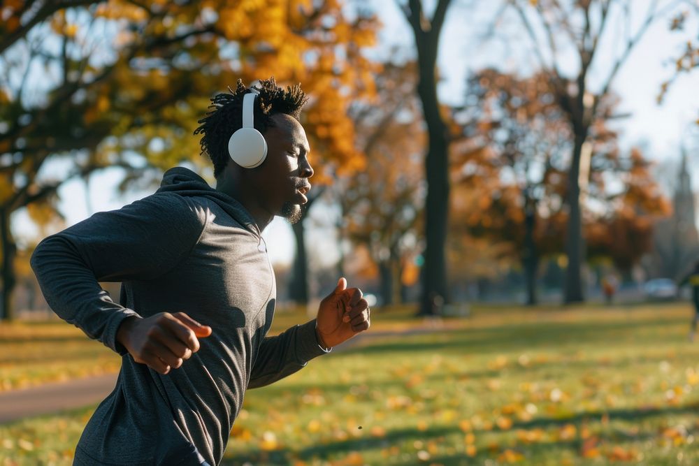 Man running electronics headphones outdoors.