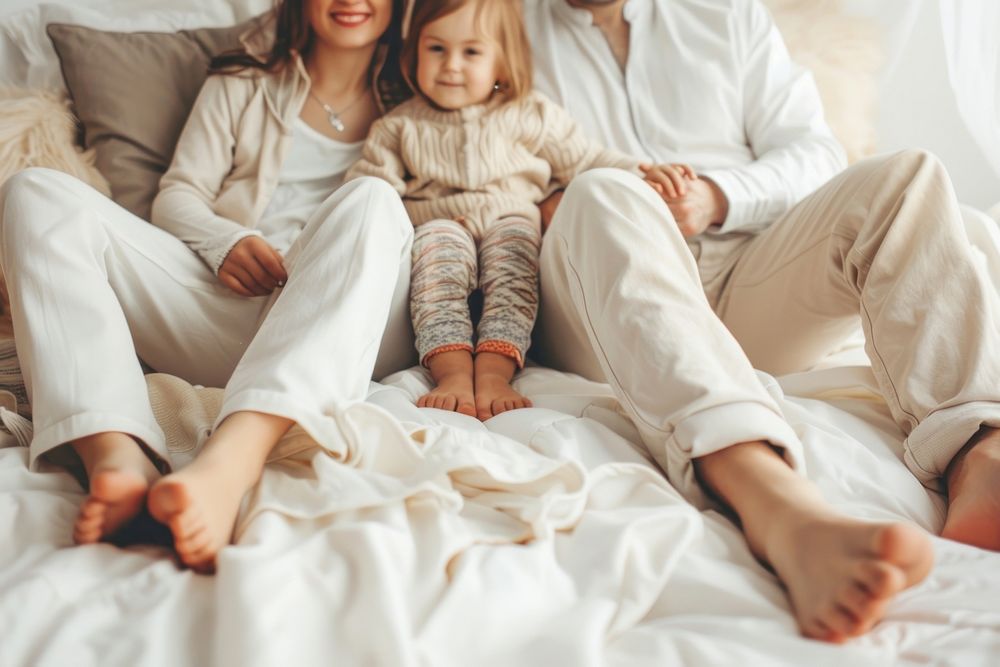 Happy white family sit together blanket baby bed.