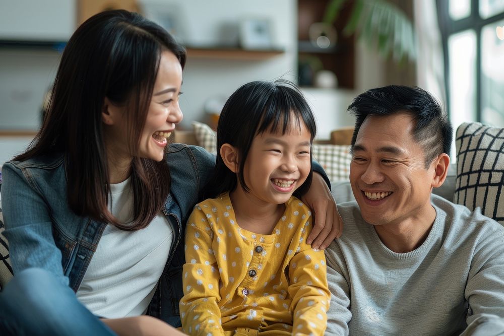 Happy asian family sit together laughing adult togetherness.