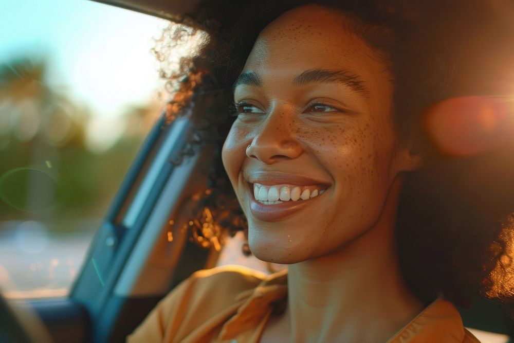 Mixed race woman driving a car window adult smile.